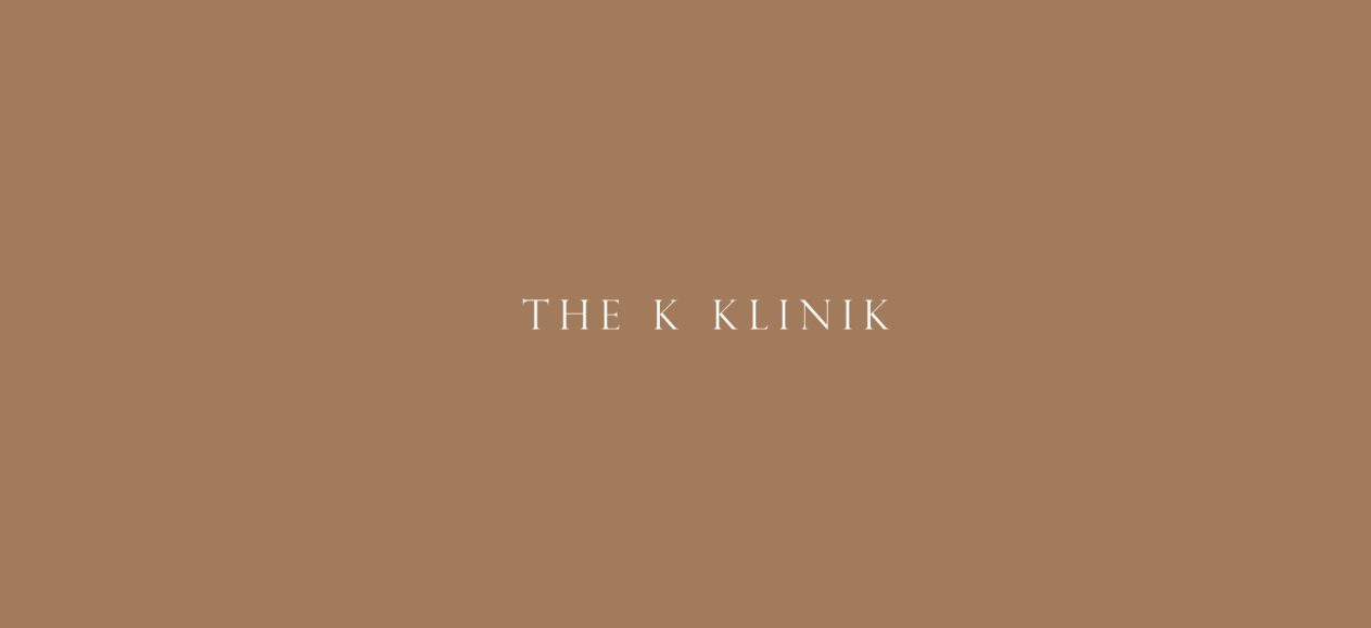 The K Klinik wordmark in white spaced serif capitals on a warm caramel-brown background