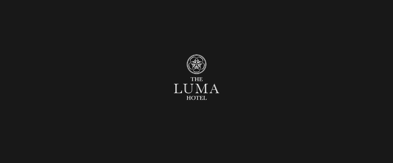 The Luma Hotel logo, a circular interlaced emblem above THE LUMA HOTEL, in white on near-black