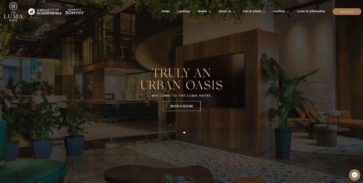 The Luma Hotel homepage hero with the lobby in low light, the words Truly an urban oasis and a Book a Room button