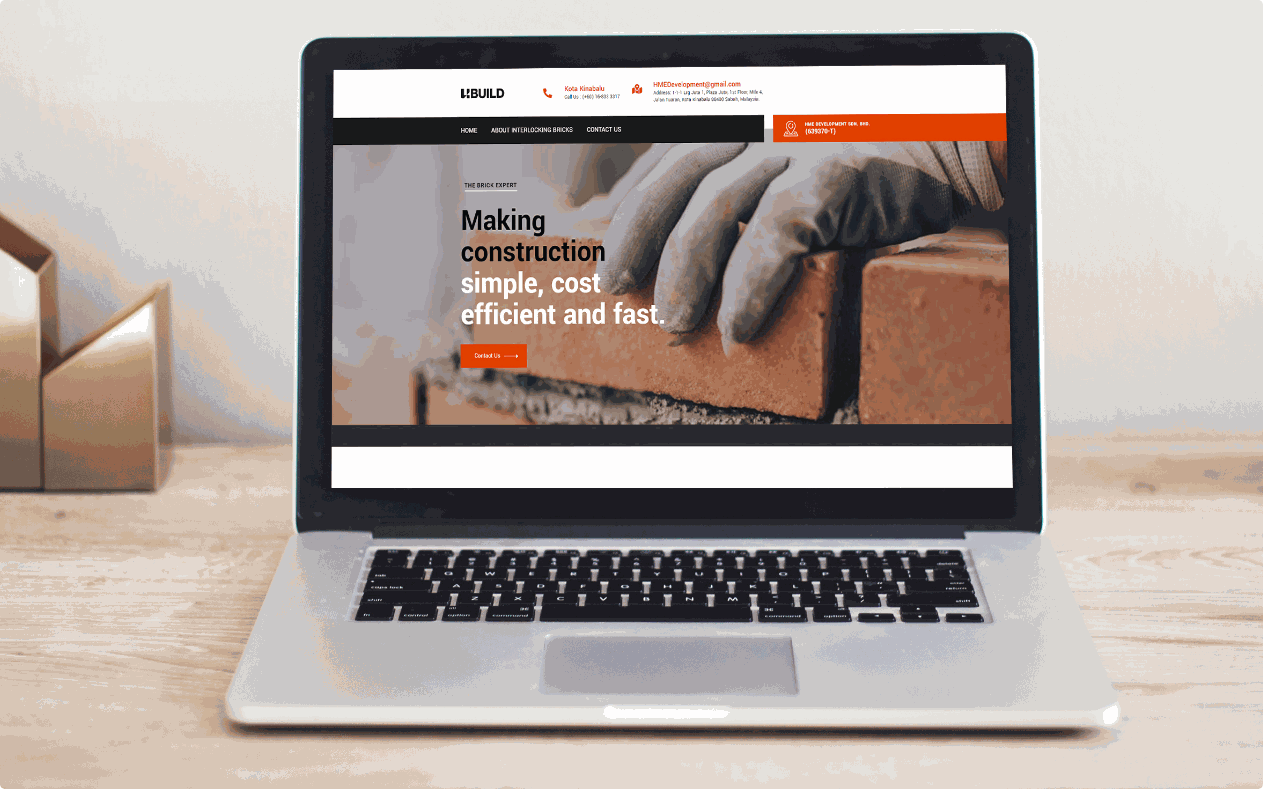 Ubuild homepage on a laptop, with a gloved hand laying a brick and the headline Making construction simple, cost efficient and fast