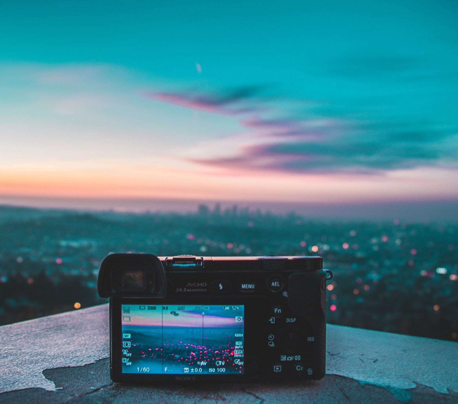 Camera filming a city skyline at dusk, representing video production by Spacebar, a social media agency Malaysia