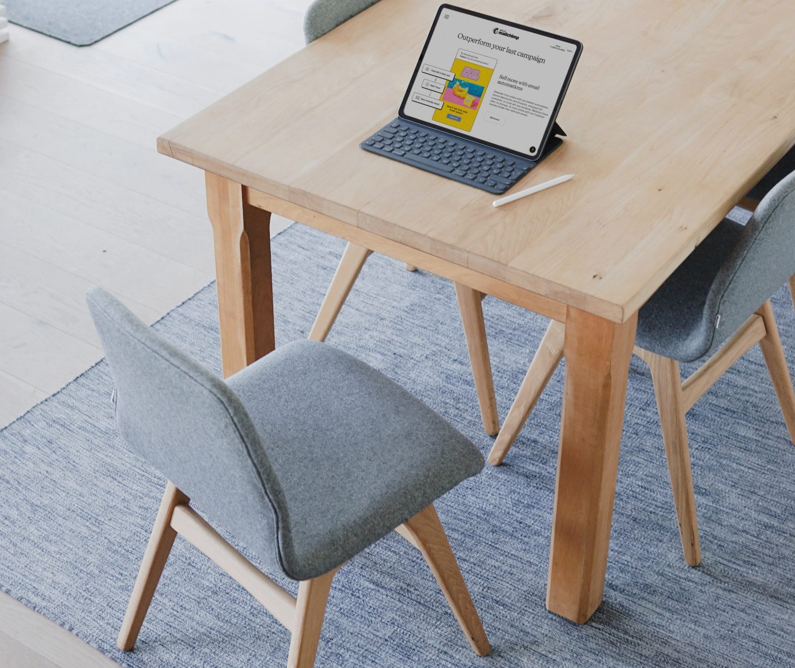 Tablet with a keyboard on a wooden desk in a bright workspace, representing Spacebar, a digital solutions agency Malaysia
